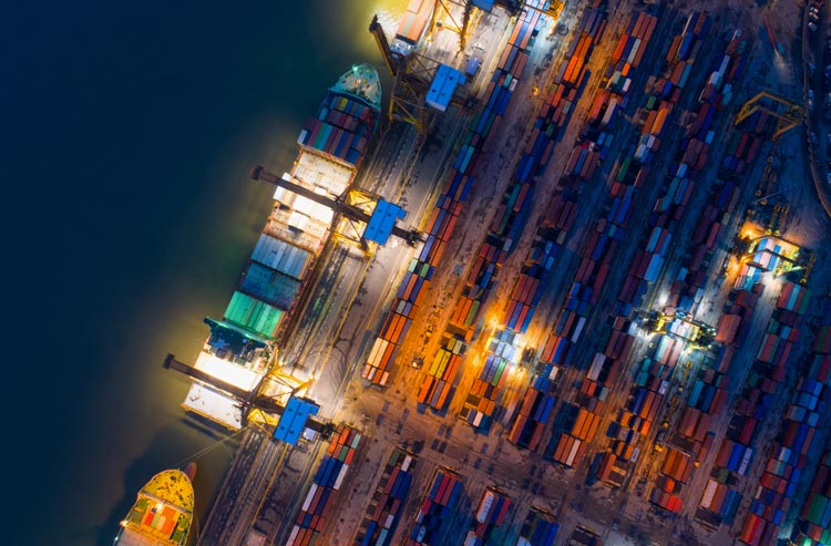 Containers yard in port congestion with ship vessels are loading and discharging operations of the transhipments in international port